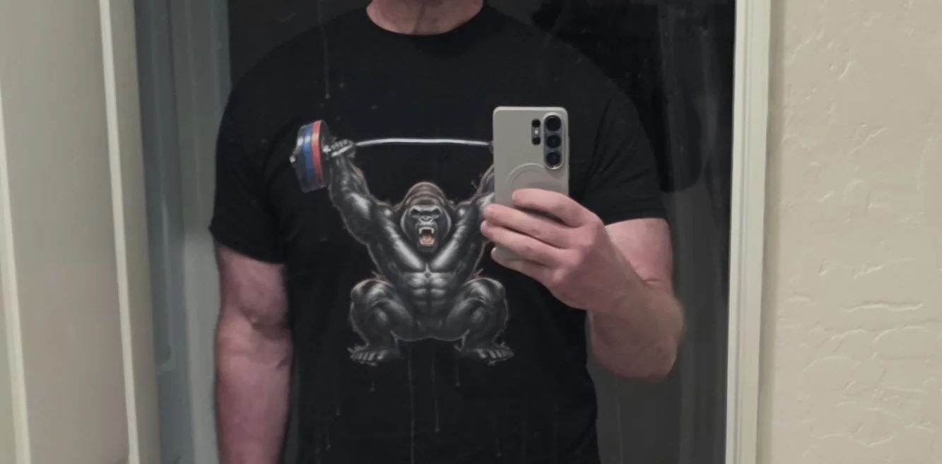 Customer wearing the black gorilla-and-barbell T-shirt in a mirror photo