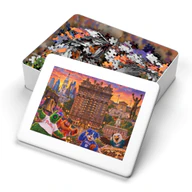 Open metal tin for the 2,000-piece Bellevue Hotel Philadelphia jigsaw puzzle, with pieces inside and artwork on the lid
