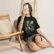 Woman wearing a black Wire Fox Terrier Halloween Ghost Rat Hunter T-Shirt while seated indoors